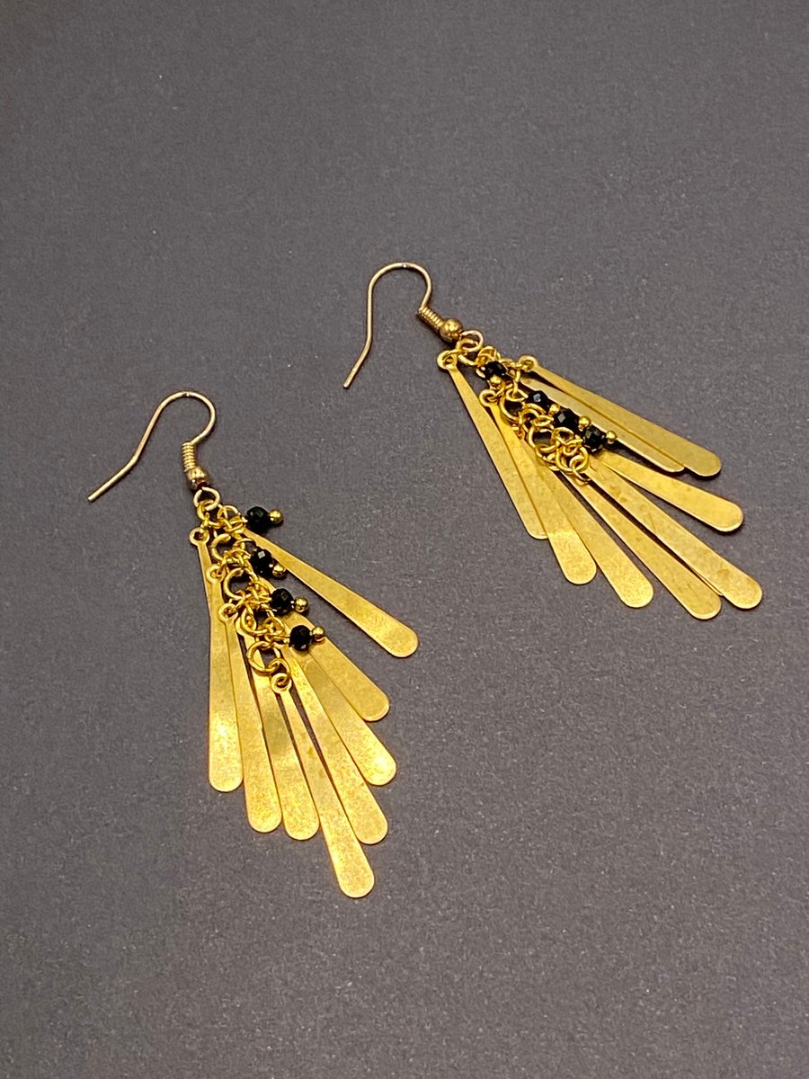 Drop shaped gold tone chandelier earrings with faceted black spinel stones