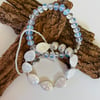Complementary trio of stretch bracelets featuring moonstone, mother of pearl 