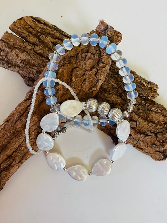 Complementary trio of stretch bracelets featuring moonstone, mother of pearl 