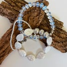 Complementary trio of stretch bracelets featuring moonstone, mother of pearl 