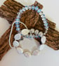 Complementary trio of stretch bracelets featuring moonstone, mother of pearl 