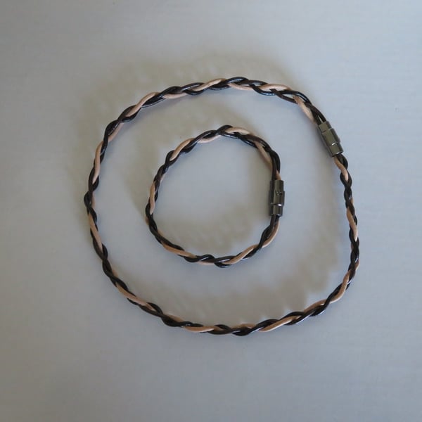 Matching choker with leather bracelet has magnetic clasp