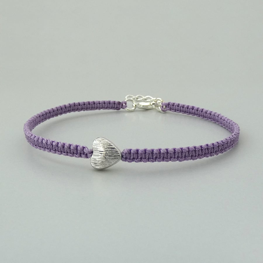Purple 7" macramé bracelet with silver plated heart charm and 1” extender chain.