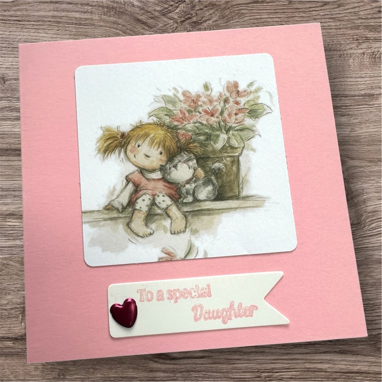 Birthday card for a special daughter.  Cute girl sat with her cat and flowers 