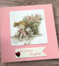 Birthday card for a special daughter.  Cute girl sat with her cat and flowers  - Image 1