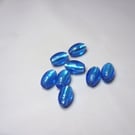 Turquoise blue foil lined rice shaped glass beads Pkt 8