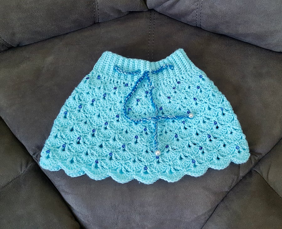 Aqua mini skirt with royal blue sequins and 3 shades of blue chord. Size XS.