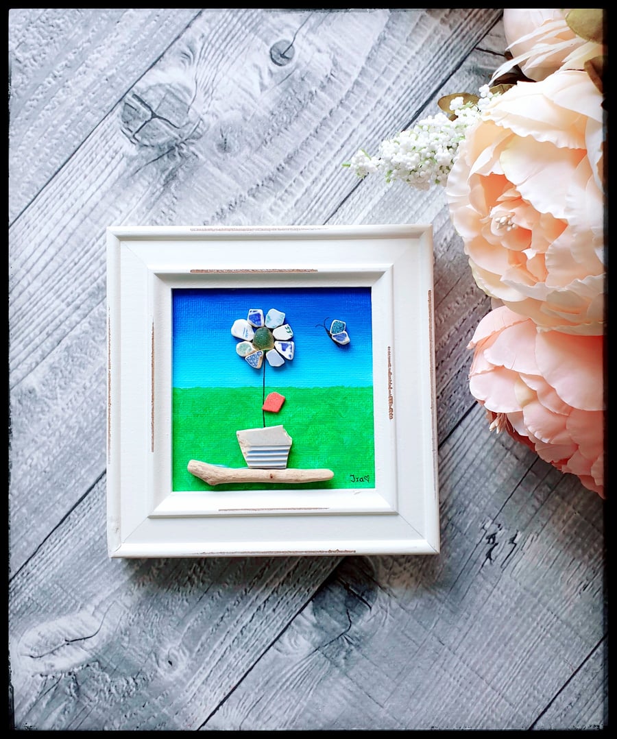 Seapottery and driftwood art of a mosaic flower
