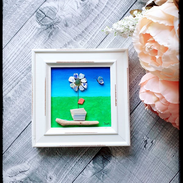 Seapottery and driftwood art of a mosaic flower