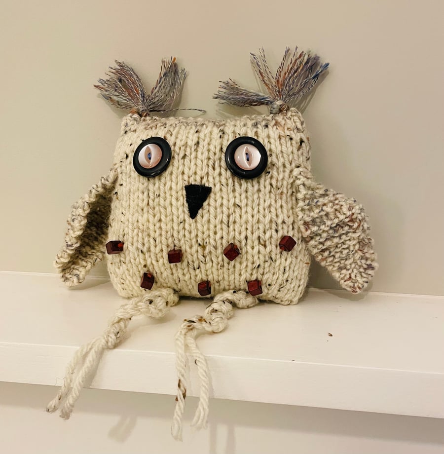 Knitted beige owl with  beads 