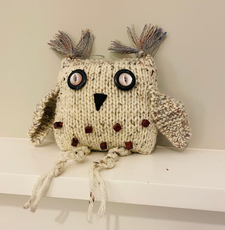 Knitted beige owl with  beads 