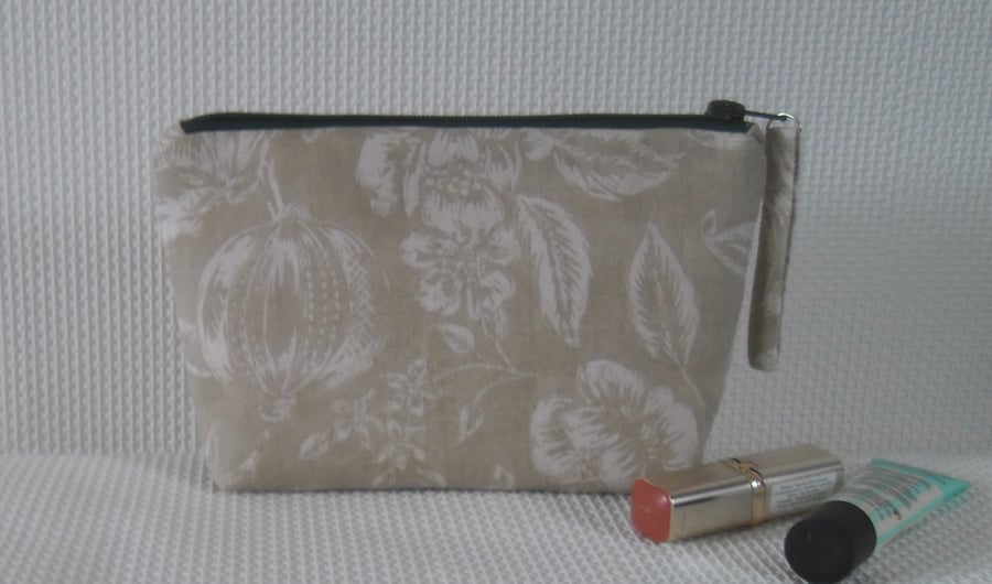 Zipped make up bag in green fabric with pink lining