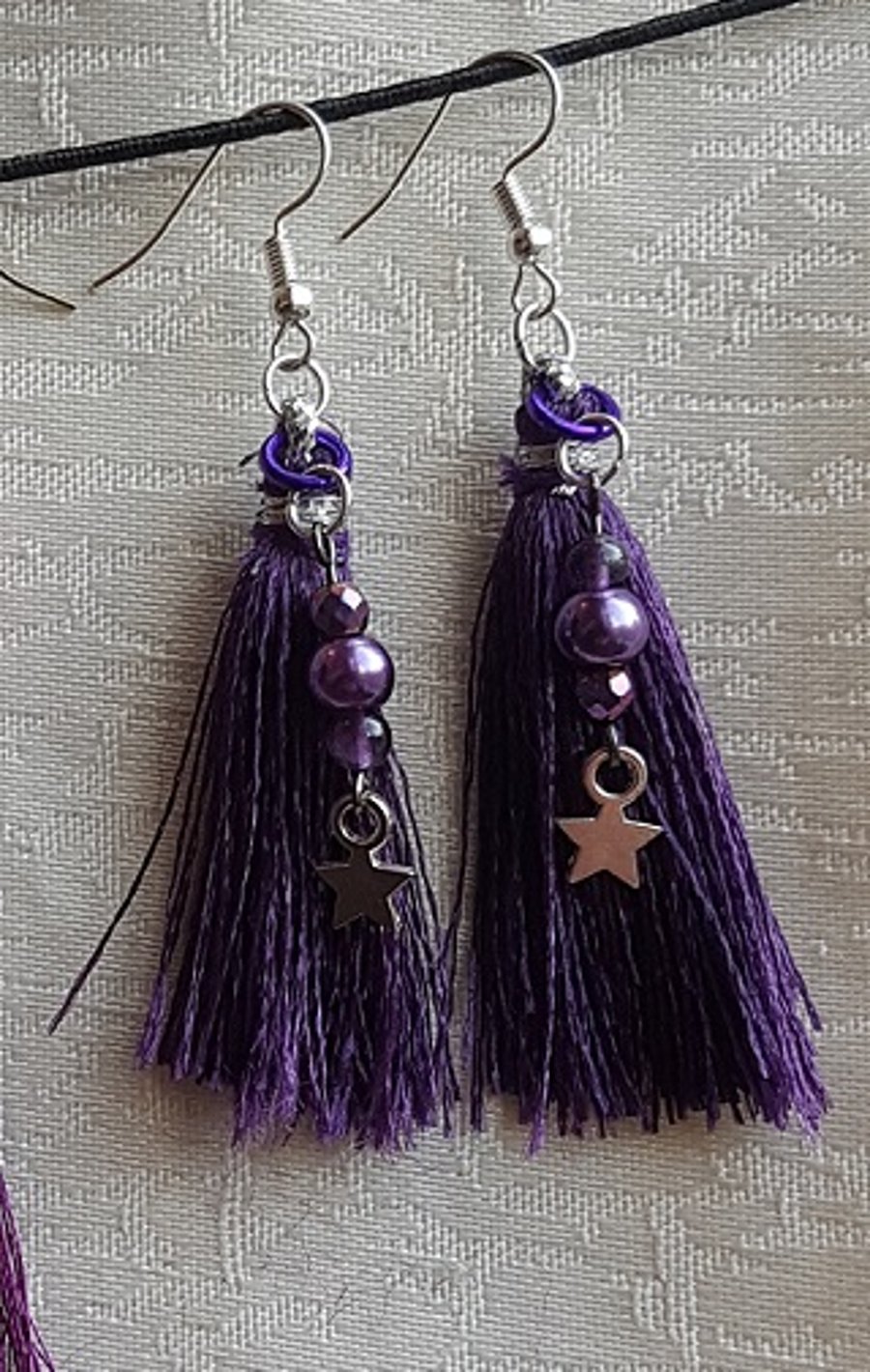 Beautiful purple tassel earrings with stars.