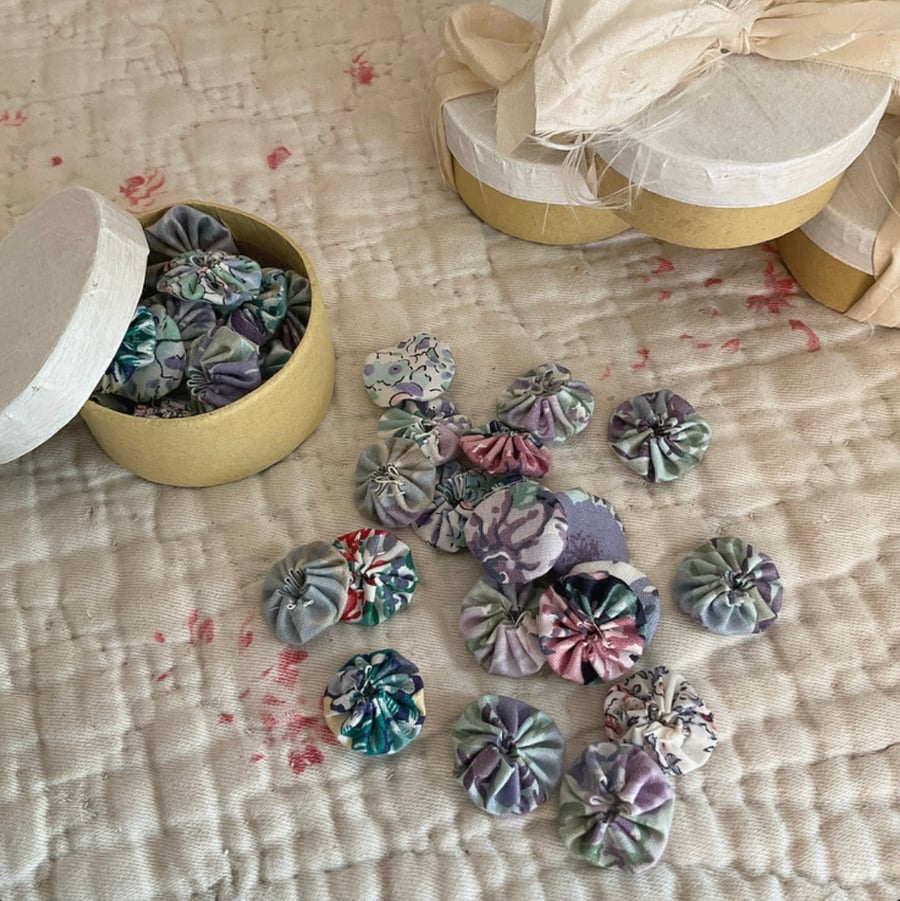 Tiny Box containing 20 Mini Suffolk Puffs (yoyo’s) in lilacs and blues