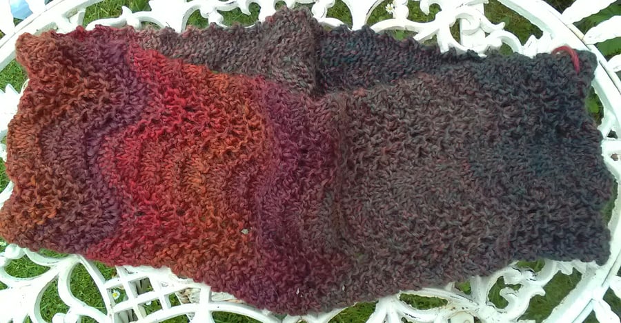 Handknit lacy textured circular scarf in multi reds and greens