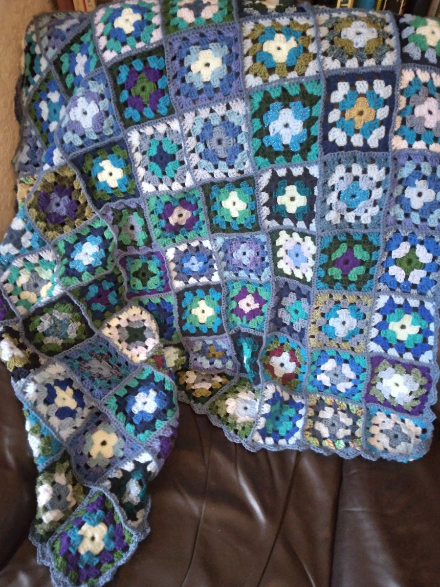 Crochet blanket in shades of blue and green. Handmade