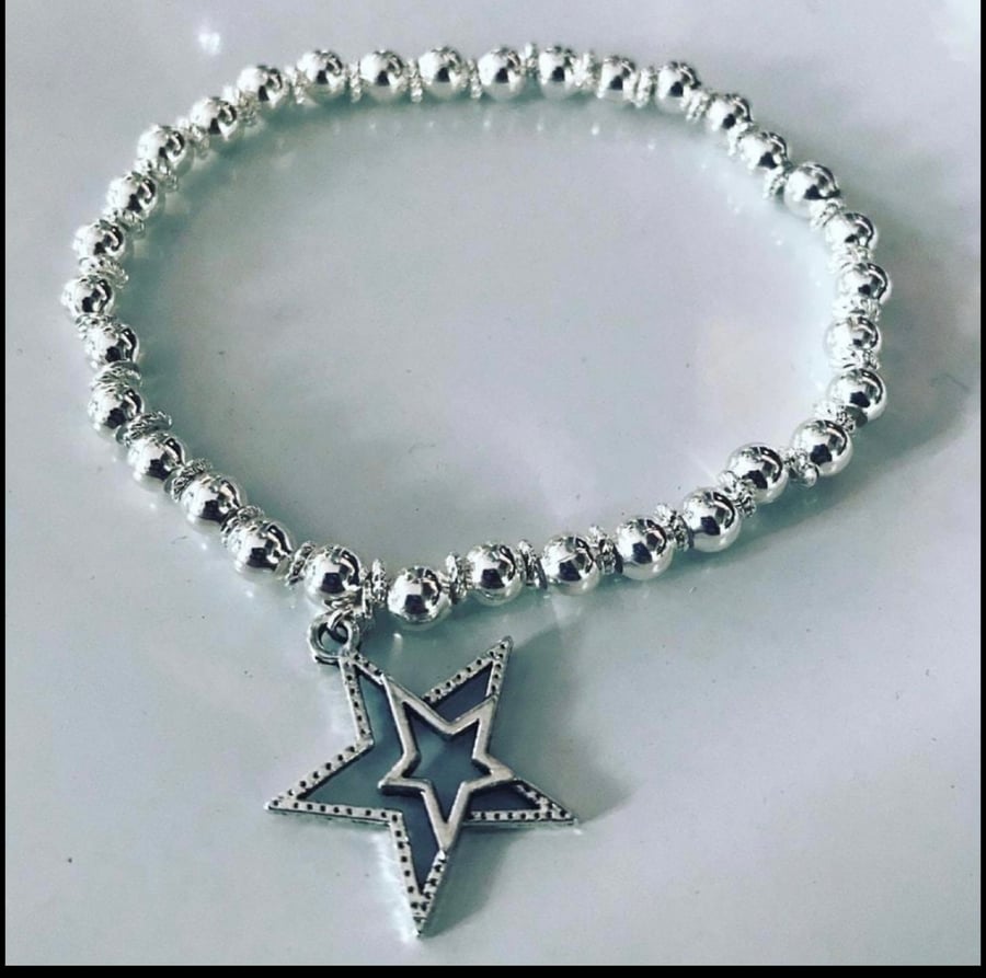 Star charm silvertone beaded bracelet 