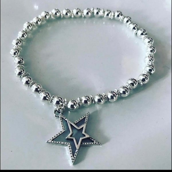 Star charm silvertone beaded bracelet 