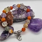 Multi-gemstone muti-coloured stretch bracelet with silver ohm charm