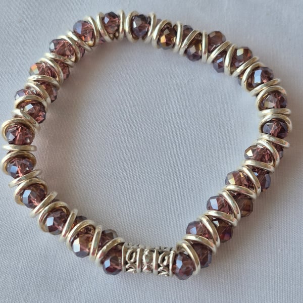 Goddess style stretcbracelet with puple glass beads and silver plated jump rings