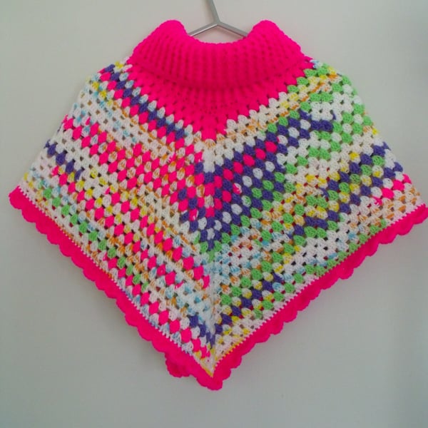girls crocheted roll neck poncho in bright pink and multicoloured yarn, 8-10y