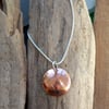 Domed, textured copper pendant on silver chain