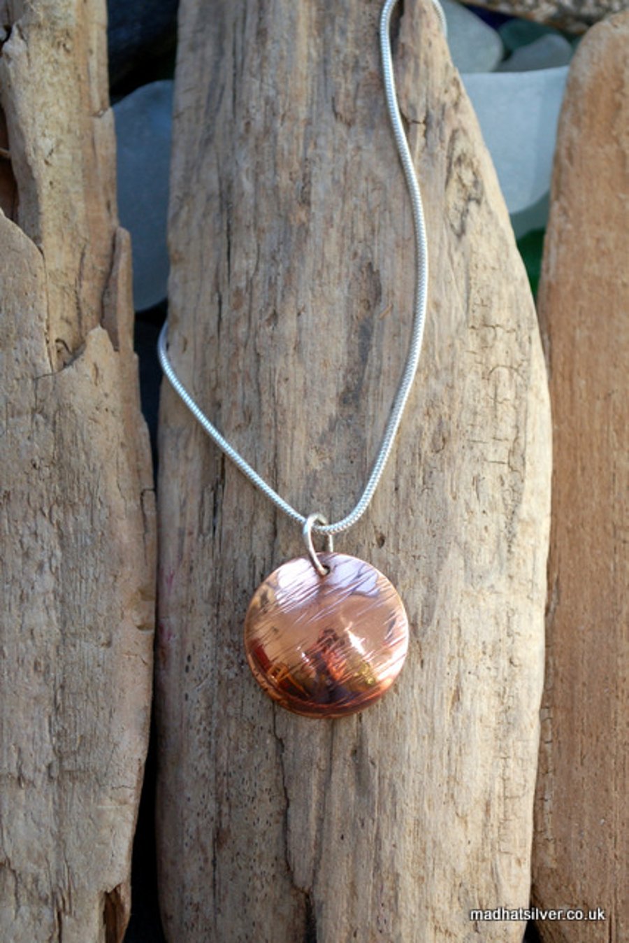 Domed, textured copper pendant on silver chain