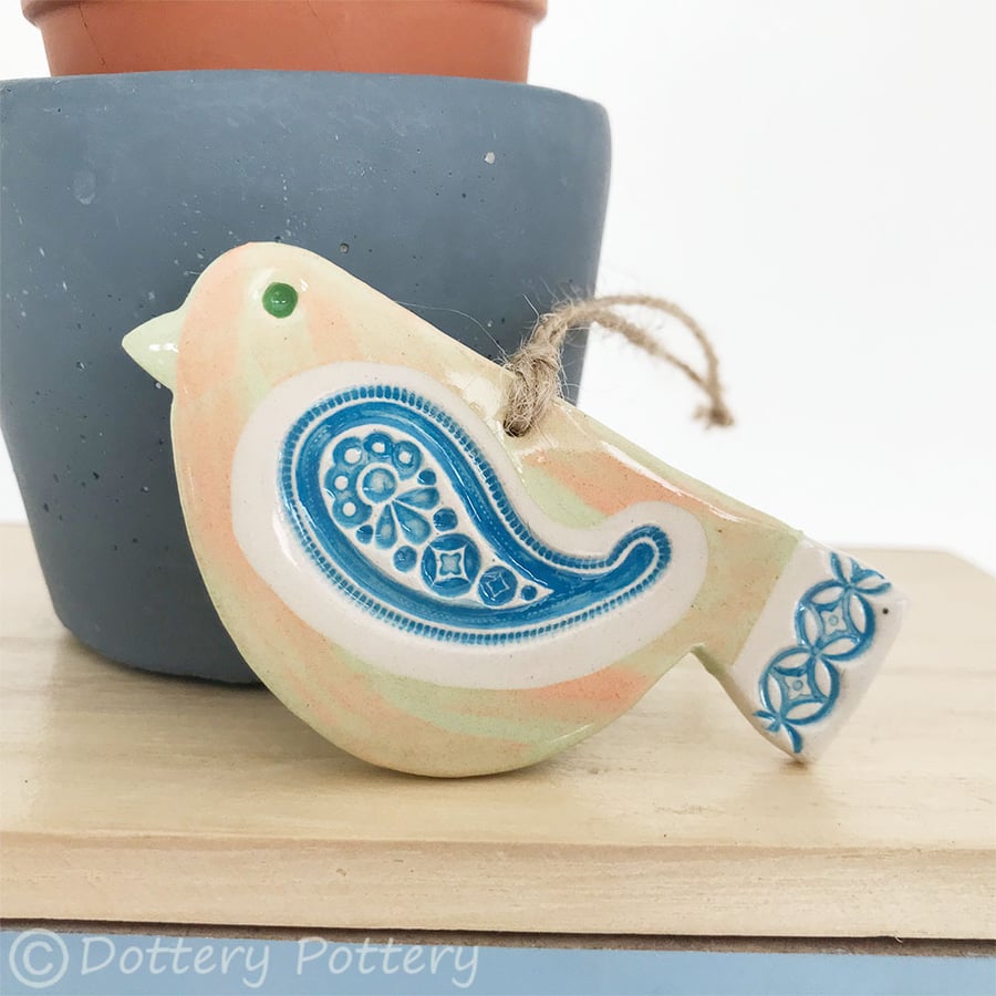 Ceramic bird decoration with patterned wing and tail 