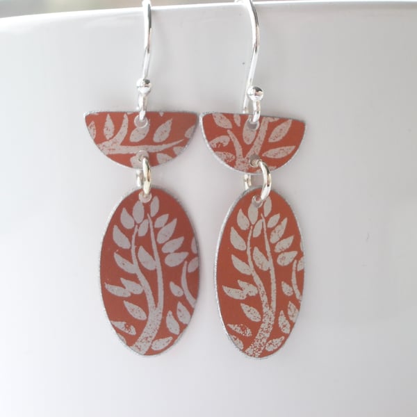 Orange oval earrings with tree print design