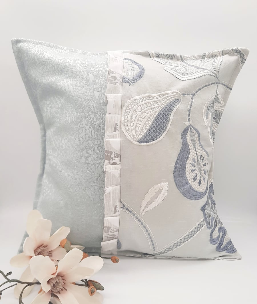 Embroidered green and blue envelope cushion cover with frill. 