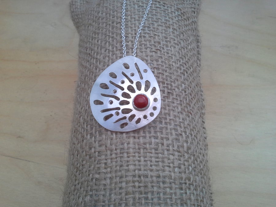 HAND PIERCED PENDANT WITH RUB OVER SET STONE 