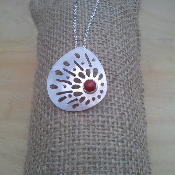 HAND PIERCED PENDANT WITH RUB OVER SET STONE 