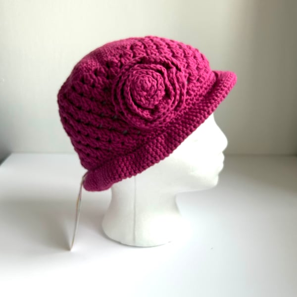 Crocheted cotton sun hat, decorated with a crocheted flower.