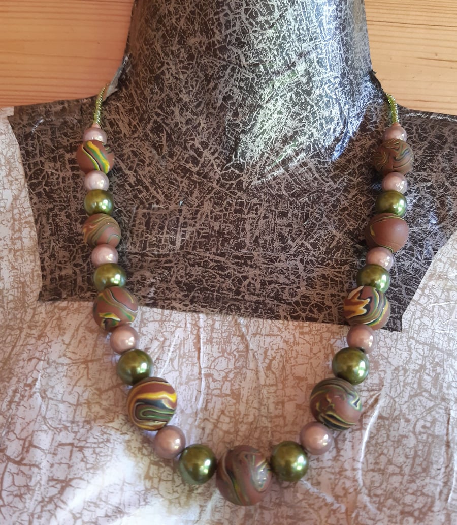 Polymer clay necklace in a brown swirl design with a hint of sparkle