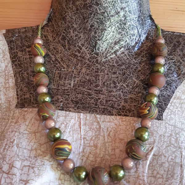 Polymer clay necklace in a brown swirl design with a hint of sparkle