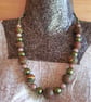 Polymer clay necklace in a brown swirl design with a hint of sparkle - Image 1