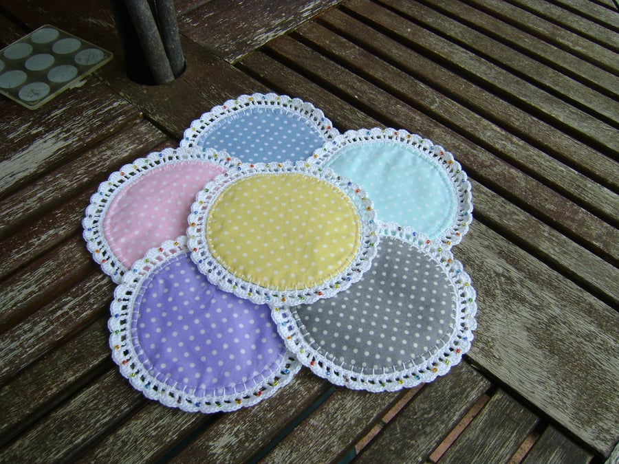 Pretty round polka dot fabric coasters.