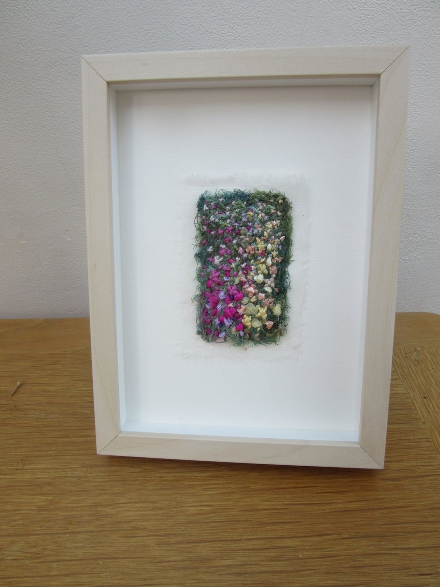 Garden embroidered picture.  Abstract summer flowers in light frame