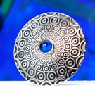 Handmade brooch, descending circle pattern and a beautiful blue Spinel gemstone