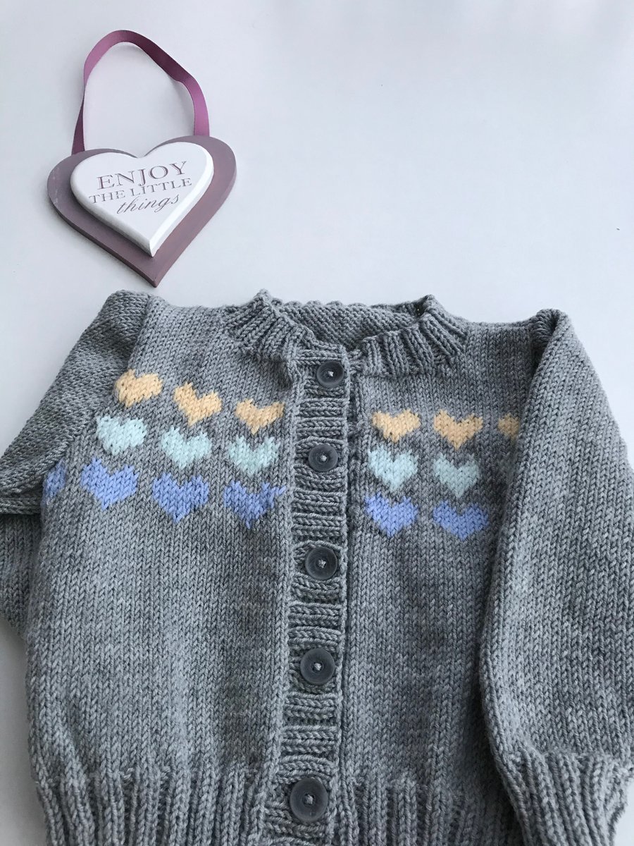 Hand knitted baby cardigan with a heart design