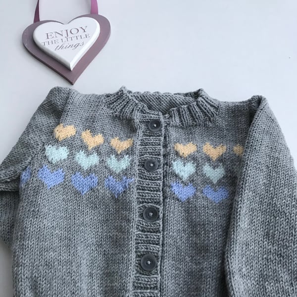 Hand knitted baby cardigan with a heart design