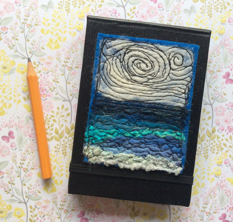 Embroidered pocket notebook. 