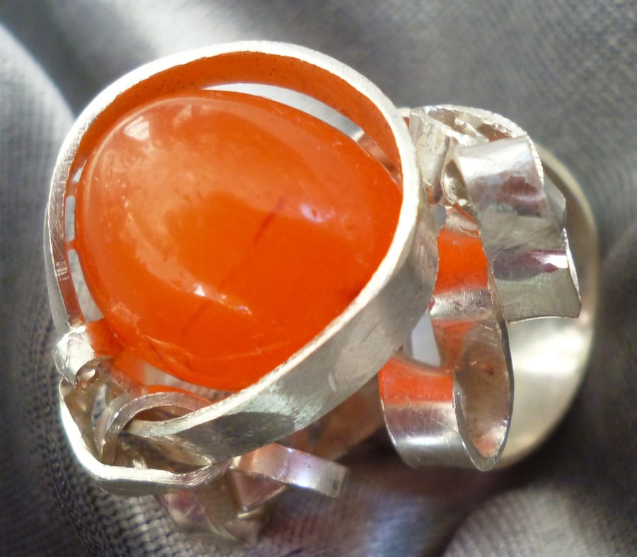Sterling silver ring wrapped around a carnelian stone