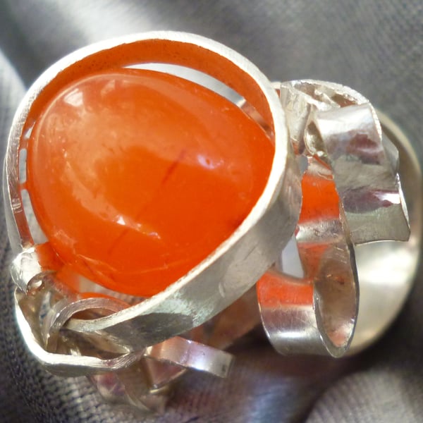 Sterling silver ring wrapped around a carnelian stone