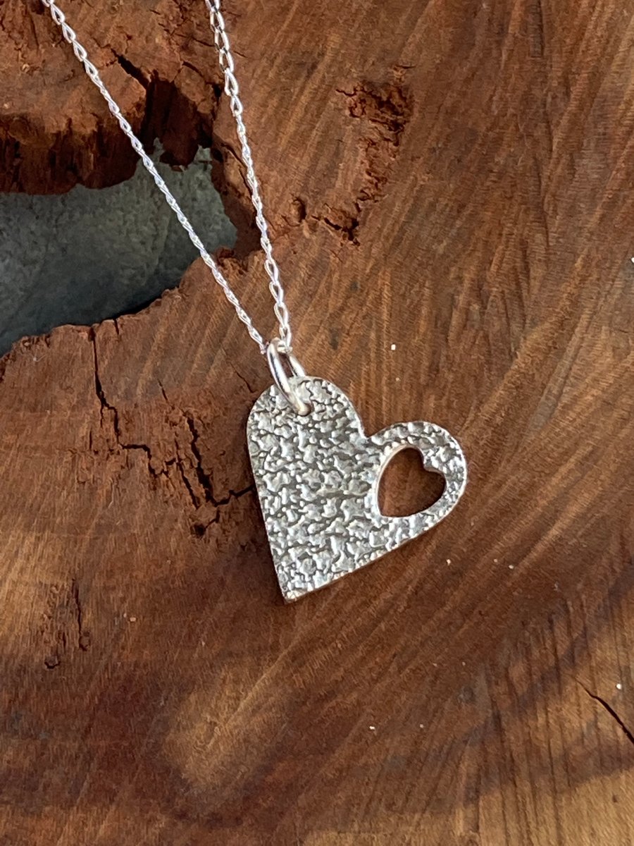 Silver heart within a heart pendant