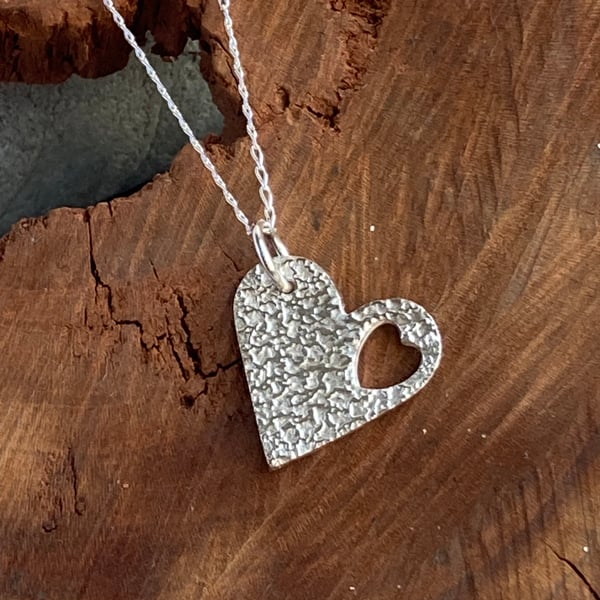 Silver heart within a heart pendant