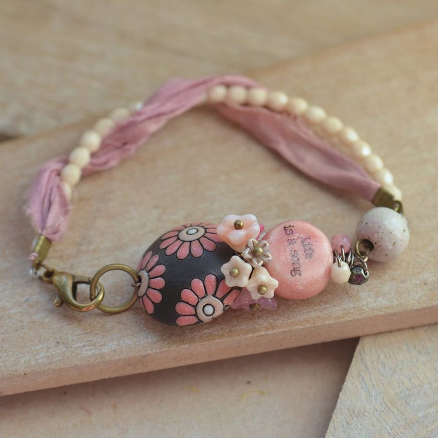 Pink and Cream Ceramic Life is a Song Bracelet with Sari Ribbon