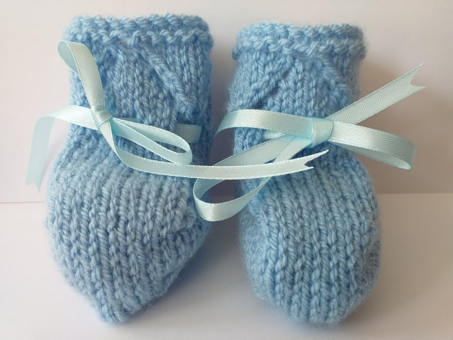 3 pairs ofNewborn Baby Boys Bootees plus a boys helmet