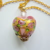 Pink and gold Murano glass heart pendant with gold chain.