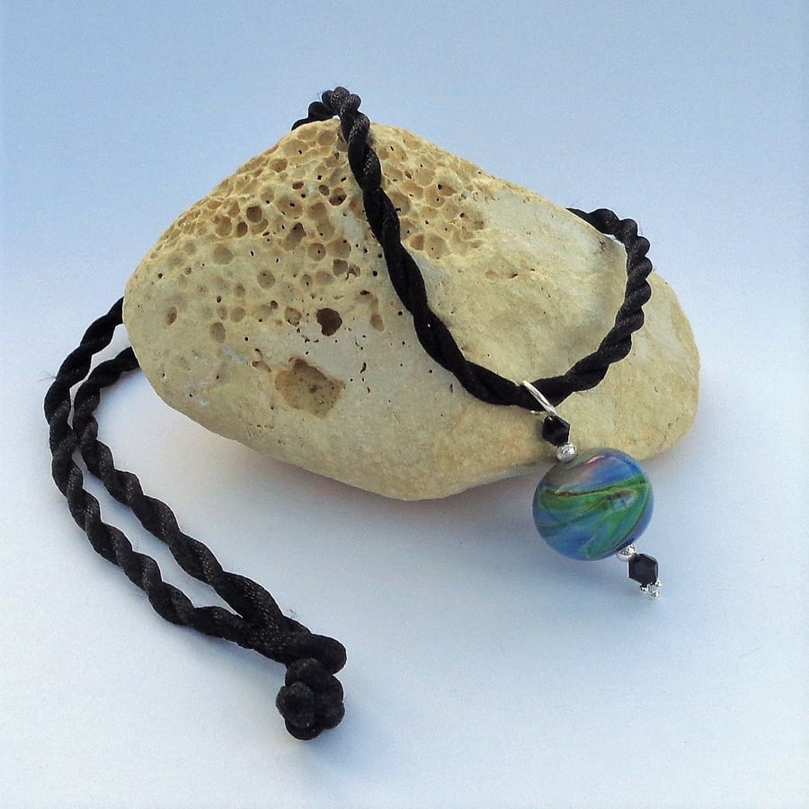 Lampwork glass bead pendant in dark blue green with black & sterling silver
